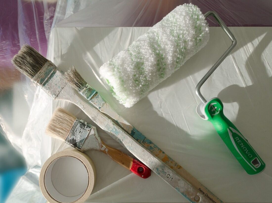 Paintbrushes and paint roller.